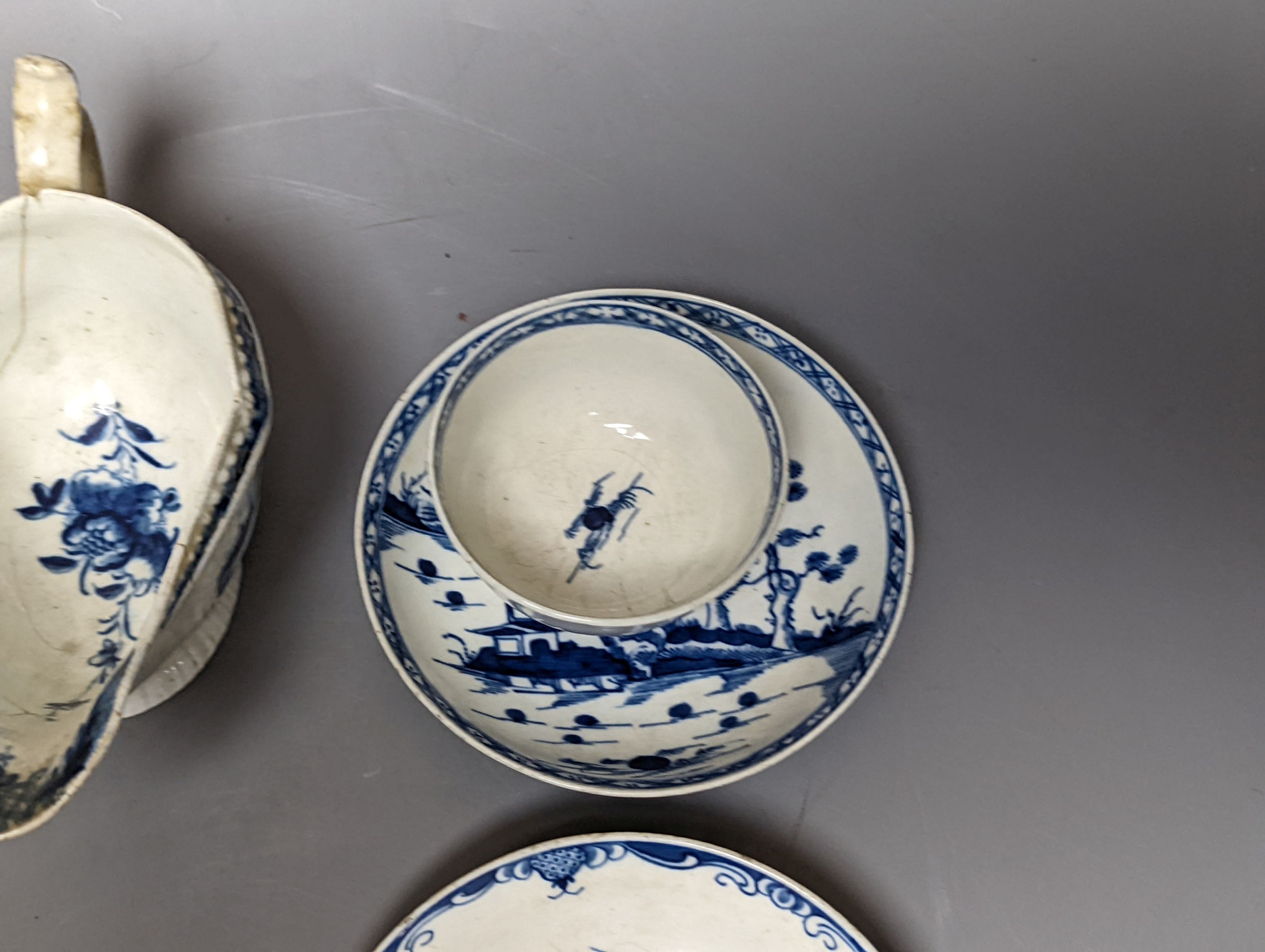 A Worcester blue and white sauceboat, two tea bowls and saucers, late 18th century and a Japanese single saucer. (7)